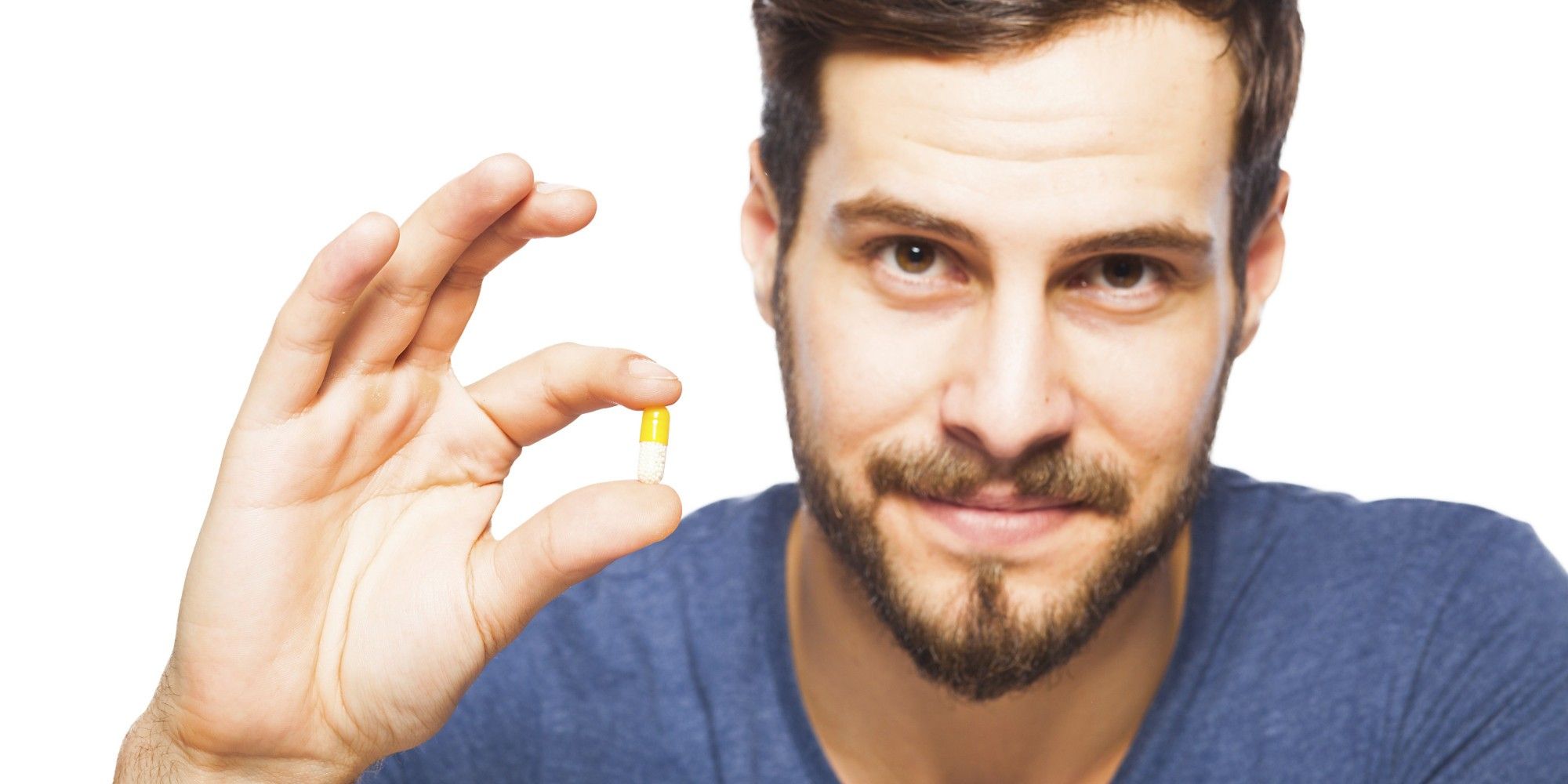 Handsome man showing pills