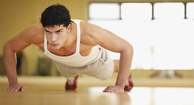 Man doing push-ups in a fitness studio