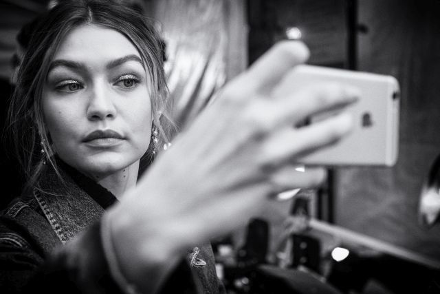 NEW YORK, NY - FEBRUARY 15: (EDITORS NOTE; image has been converted to black and white) Gigi Hadid backstage at the Tommy Hilfiger Women's Fall 2016 show during New York Fashion Week: The Shows at Park Avenue Armory on February 15, 2016 in New York City. (Photo by Grant Lamos IV/Getty Images for Tommy Hilfiger)